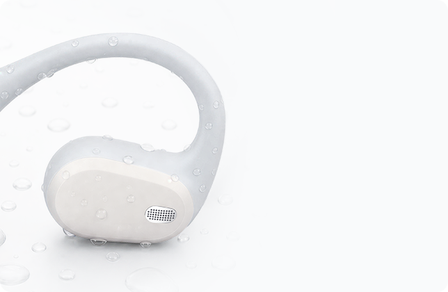 Close-up of the white AirWave Pro2 speaker grille with water droplets, highlighting sealed protection for sweat and light rain.
