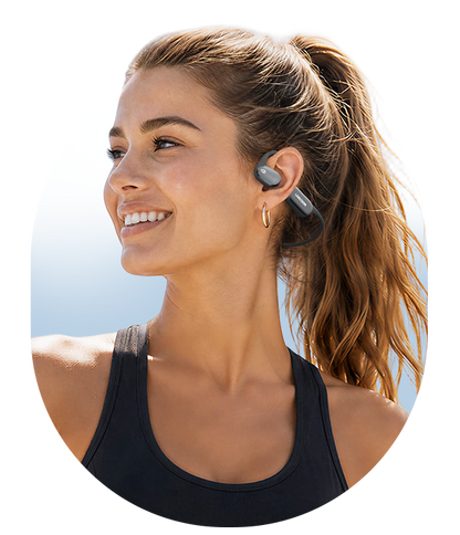 Man running outdoors while wearing AirWave Pro2 open-ear sports headphones in Storm Gray