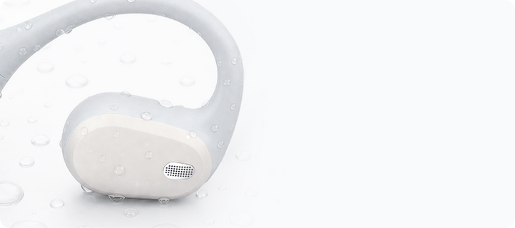 Close-up of the white AirWave Pro2 speaker grille with water droplets, highlighting sealed protection for sweat and light rain.
