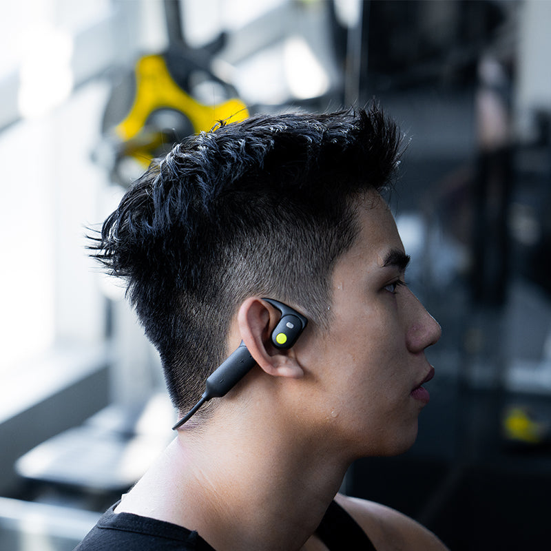 A Man Wearing AirWave Open-Ear Sport Headphones at Gym